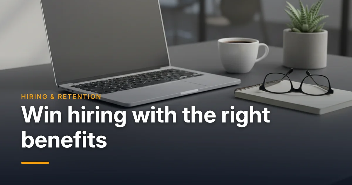 A laptop and resume documents on an office desk — using employee benefits as a competitive advantage in hiring