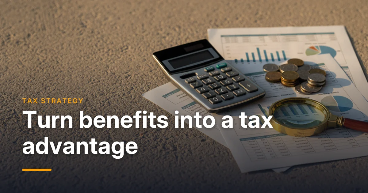 A calculator, tax forms and a pen on a desk — using group benefits to reduce corporate taxes in Canada