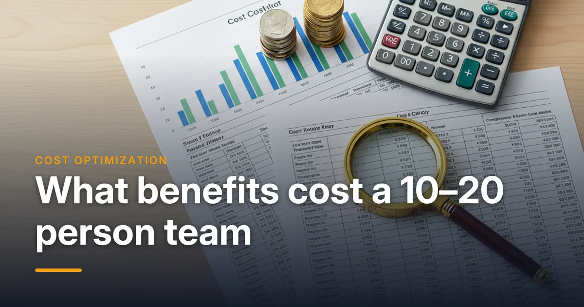 A calculator, cost charts and coins on a desk — group benefits cost for a 10 to 20 employee company in Canada